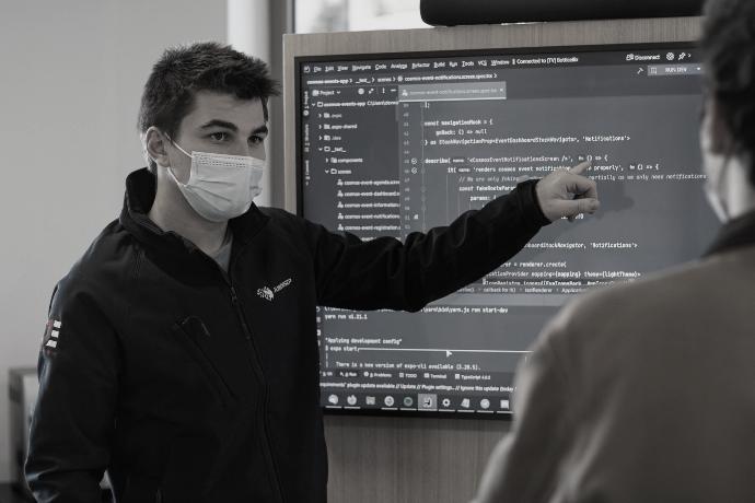 man in black jacket wearing white face mask